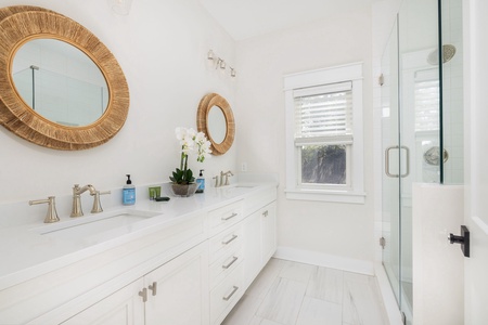 En suite bathroom features a dual vanity and walk-in shower