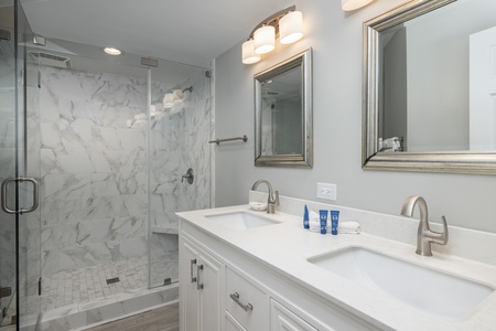 Your primary king bedroom features an en suite bathroom with dual vanity and walk-in shower