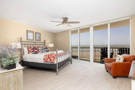 Wake up to endless ocean views from your comfortable primary bedroom, featuring a king bed and en suite bathroom