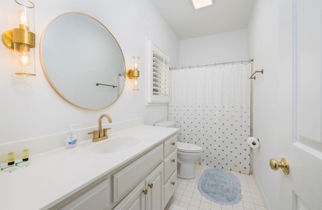 Step into your beautiful primary bathroom with a spacious vanity and tub-shower combo