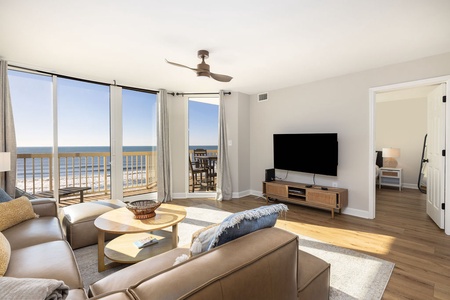 Relax in your bright living space with stunning ocean views streaming through floor-to-ceiling windows.