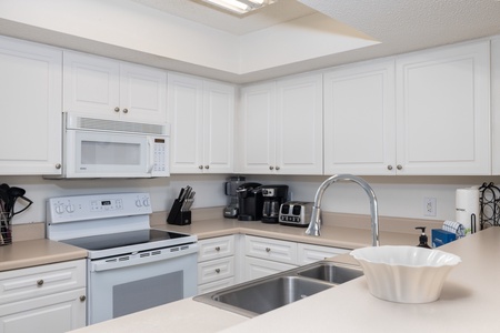 Your kitchen looks out onto the living area and views of the ocean beyond