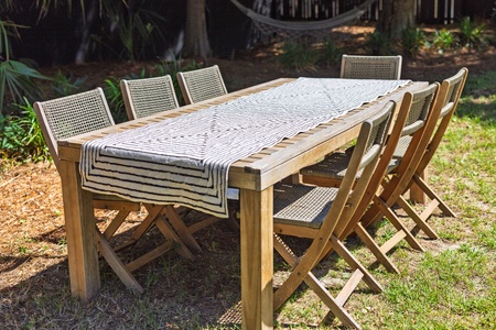 A large and elegant dining table is ready for meals under the stars
