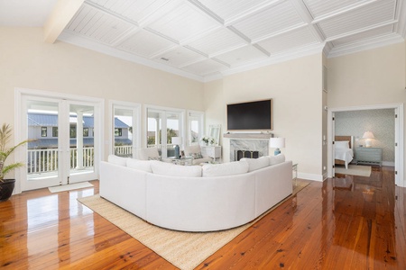 Step into your bright and spacious living room with rounded sectional sofa and a modern fireplace