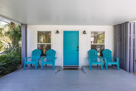 Underneath the Sandy Cheeks Beach House sign, you'll find your covered patio with entry to the downstairs living space