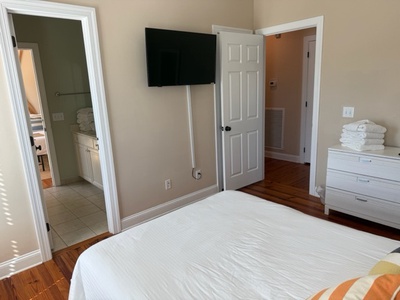 Unwind in your peaceful bedroom with flat-screen TV, pristine linens, and ensuite bathroom for ultimate comfort.