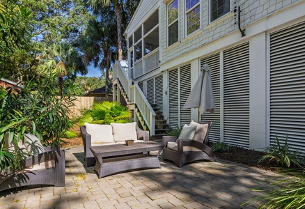 Catch some rays next to the pool on this cozy patio.