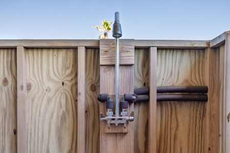 Step into your private outdoor oasis where warm water flows from this rustic outdoor shower, perfect for rinsing off after sunny days.