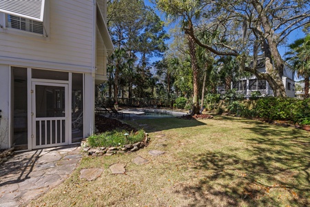Step onto your private patio and soak in the tranquil backyard oasis, complete with sparkling pool and mature tropical landscaping.