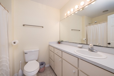 Your queen bedroom features an ensuite bathroom with large vanity and tub/shower combination