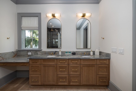 Your king en suite bathroom features a dual vanity, tiled walk-in shower, and deep soaking tub