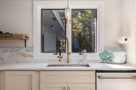 Windows above the sink make it easy to keep an eye on the family