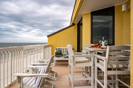 Savor morning coffee or evening wine on your private oceanfront balcony, where white coastal furniture meets endless sea views.