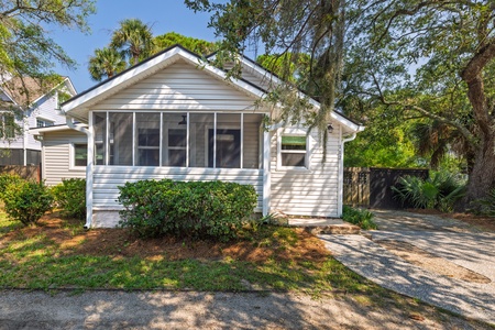 Your Folly Beach bungalow is surrounded by mature trees, offering a peaceful setting