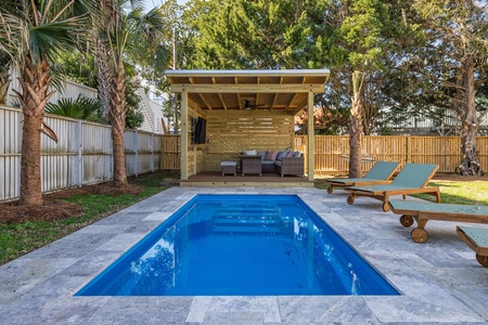 Your private poolside paradise awaits with crystal-clear waters, comfy loungers, and a shaded cabana perfect for relaxing in tropical surroundings.