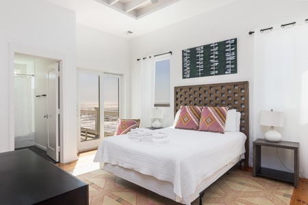 The upstairs queen bedroom has access to the porch and its own en suite bathroom