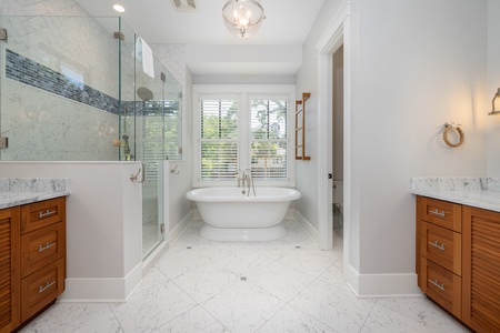 The primary en suite bathroom is a spa-like retreat