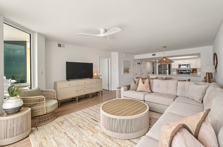 Sink into plush sofas in your bright, open living space where natural textures and modern comfort create the perfect retreat.