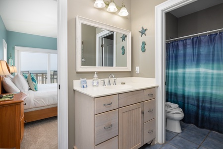 Your downstairs king bedroom features an en suite bathroom with tub-shower combo