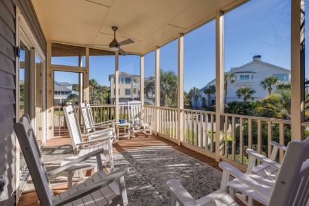 Relax on your private screened porch with comfortable seating and peaceful coastal views