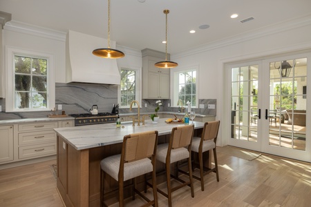 French doors take you to your outdoor dining area overlooking the pool
