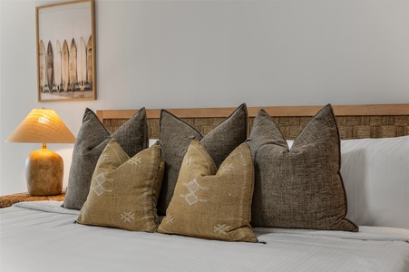 Sink into this plush bed with its carefully arranged pillows and warm bedside lighting creating the perfect atmosphere for your restful retreat.