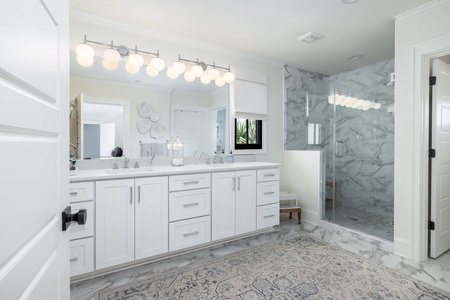 Freshen up in your luxurious primary bathroom, with marble floors, marble shower, and dual vanity