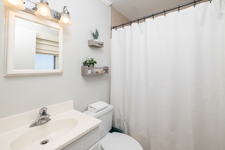 The primary en suite bathroom features a tub-shower combo and single vanity
