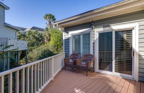 Your primary downstairs bedroom steps out onto a private balcony
