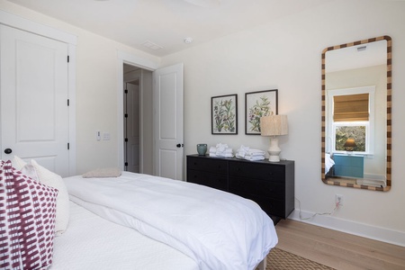 Drift off to sleep in your peaceful retreat featuring crisp white linens, elegant botanical artwork, and thoughtful touches that make you feel right at home.