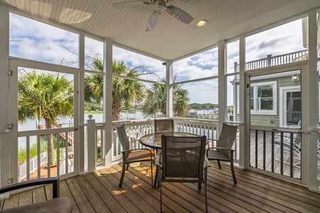 Relax in your screened porch with ceiling fan, where you can enjoy peaceful water views framed by swaying palms—perfect for morning coffee or evening conversations in the fresh coastal breeze.
