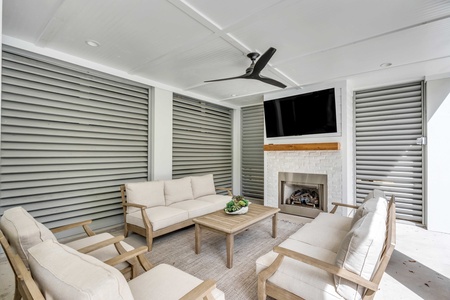 Your covered patio lounge features tons of seating and a large television over the outdoor fireplace