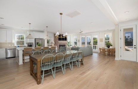Your open-concept kitchen flows into a dining area where everyone gathers around the farmhouse table for memorable meals together.