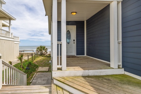 Follow the stairs to the back of the house to access the beach
