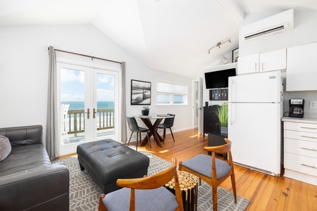 Your coastal retreat awaits with gleaming hardwood floors, comfortable modern furnishings, and breathtaking ocean views through glass doors that open to your private deck. Relax and unwind while enjoying the sound of the waves just steps away.