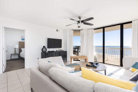 Stylish and comfortable living space with plush seating, smart TV, and wide ocean views to make every moment by the beach relaxing