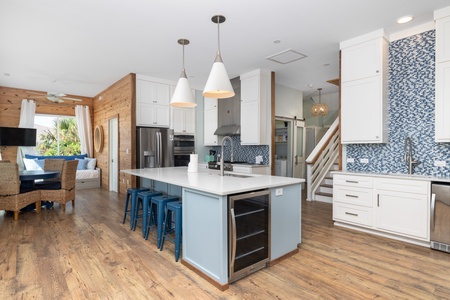 The large center island with wine fridge is perfect for gathering around
