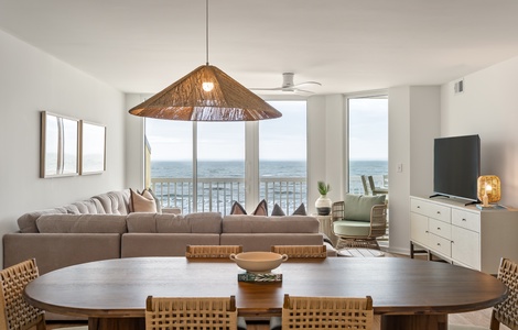 Sink into plush seating while ocean waves dance beyond your floor-to-ceiling windows in this bright, coastal-inspired living space.