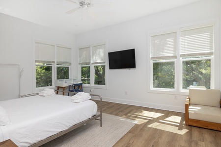 Step into your primary bedroom, featuring a king size bed, en suite bathroom, and beautiful Folly Beach views