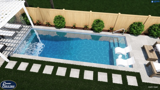 Aerial view of a private pool and landscaped backyard surrounded by lush greenery and stone pathways.