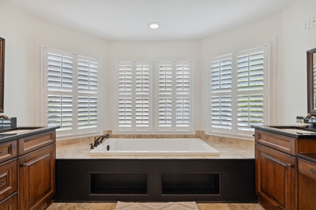 Enjoy the deep soaking tub in your primary en suite bathroom
