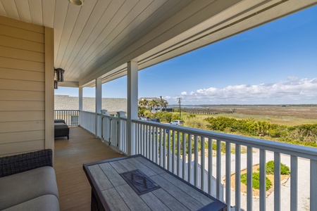Spacious covered balcony offers stunning natural landscape views across wetlands and coastal scenery.