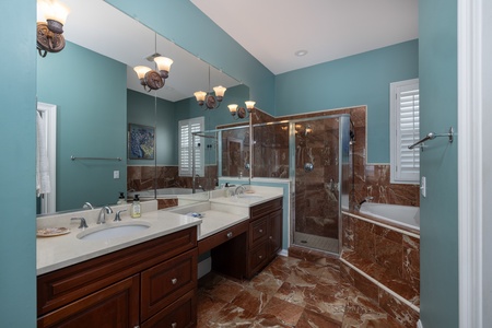 Your primary en suite bathroom is a spa-like retreat with jacuzzi tub