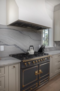 Your gourmet kitchen features stunning marble backsplash and professional-grade appliances for memorable cooking experiences.