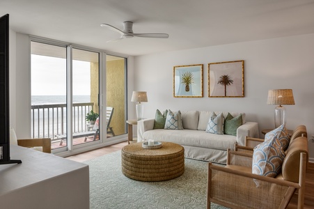 Unwind in your bright coastal living room where ocean breezes flow through sliding doors to your private balcony overlooking the sea.