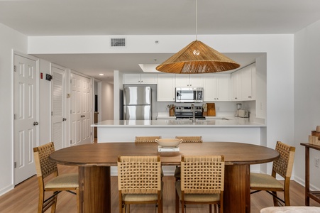 Gather around your stylish dining table beneath the striking woven pendant light, with a fully-equipped kitchen ready for memorable meals together.