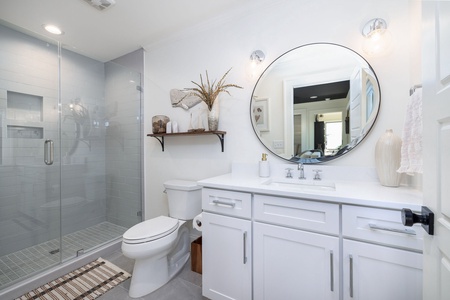 Refresh in your elegant bathroom featuring marble countertops, a spacious glass shower, and thoughtful design touches that make every morning feel luxurious.