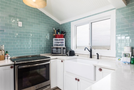 Step into your bright, fully-equipped kitchen with views of the ocean
