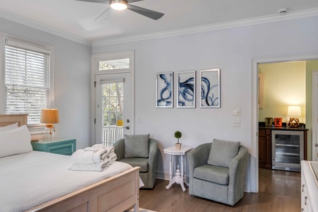 Relax in your elegant bedroom with cozy armchairs and artistic touches creating the perfect retreat.