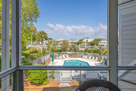 Beautiful marina and pool views from your private screened-in porch, where you can watch the boats while enjoying the coastal breezes